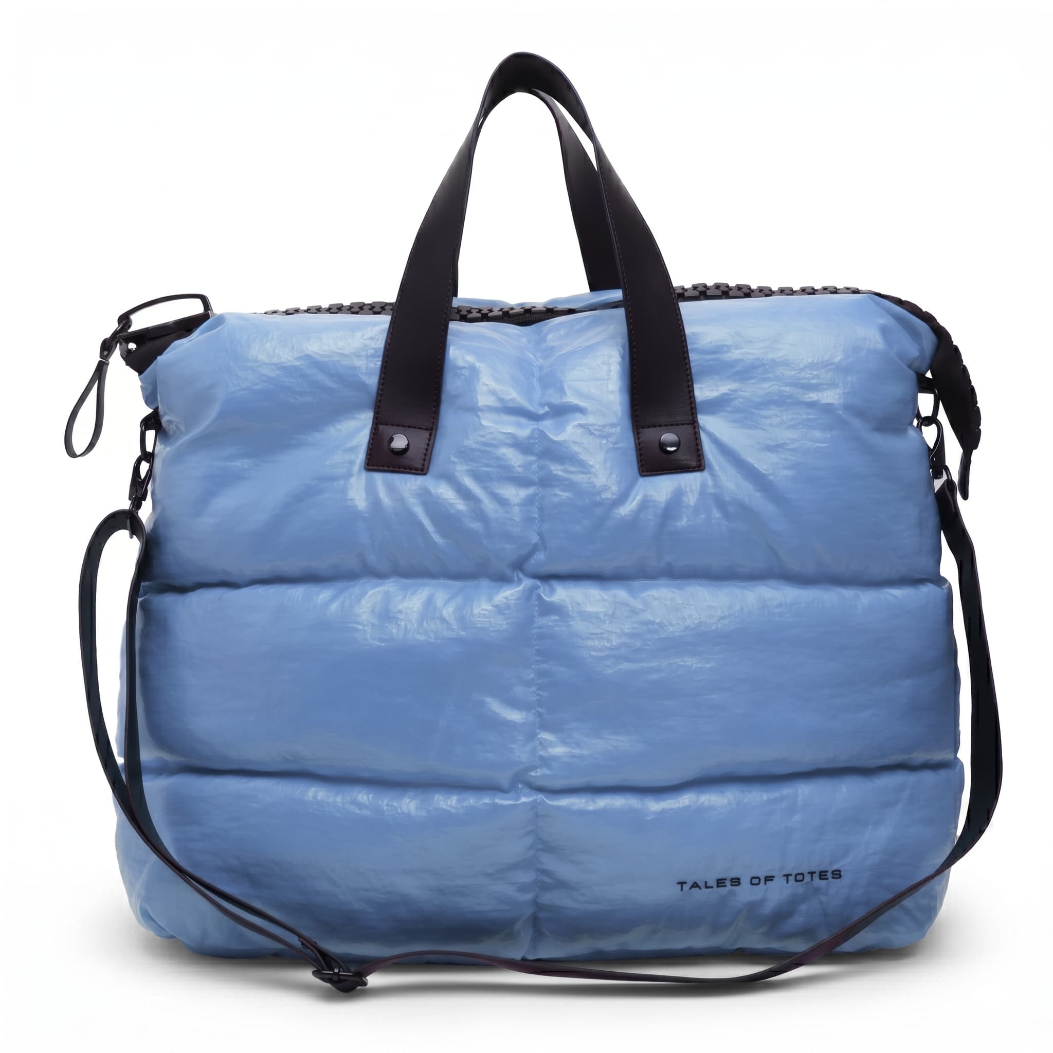 Blue puffer bag with black straps on a white background