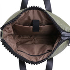 Green duffel bag with black interior and trim on a white background