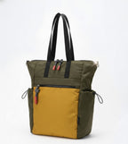 Two-toned green and mustard yellow tote bag with black straps on a white background
