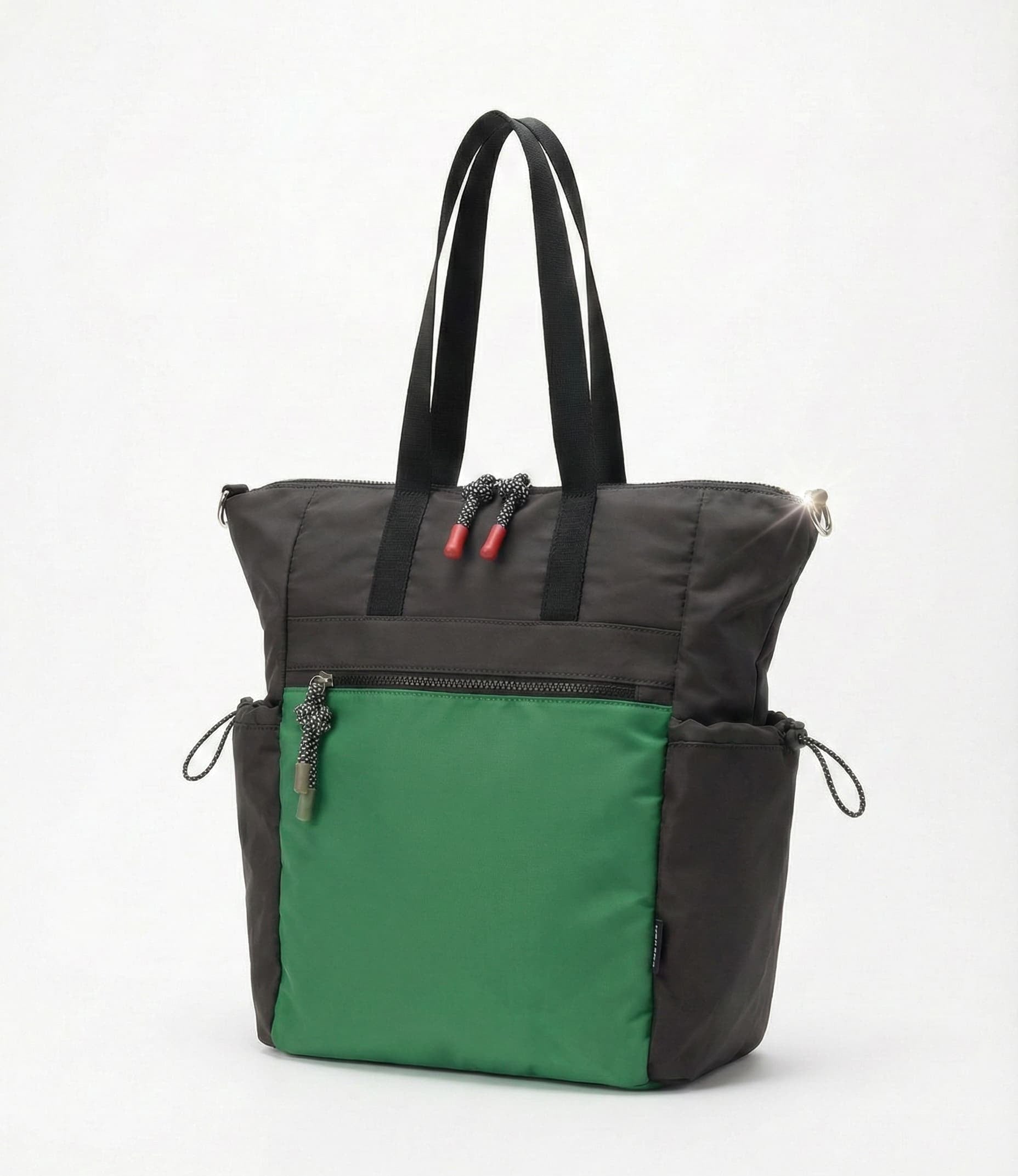 Two-toned black and green tote bag on a white background