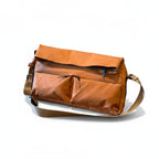 Brown leather bag with a shoulder strap on a white background Brown backpack on a white background,A padded, water-resistant shoulder bag with a roomy interior, zip closure, and adjustable strap, designed for everyday carry and positioned as a stylish alternative to popular Indian brands like Zouk, Miraggio, Lavie, Caprese, and DailyObjects.