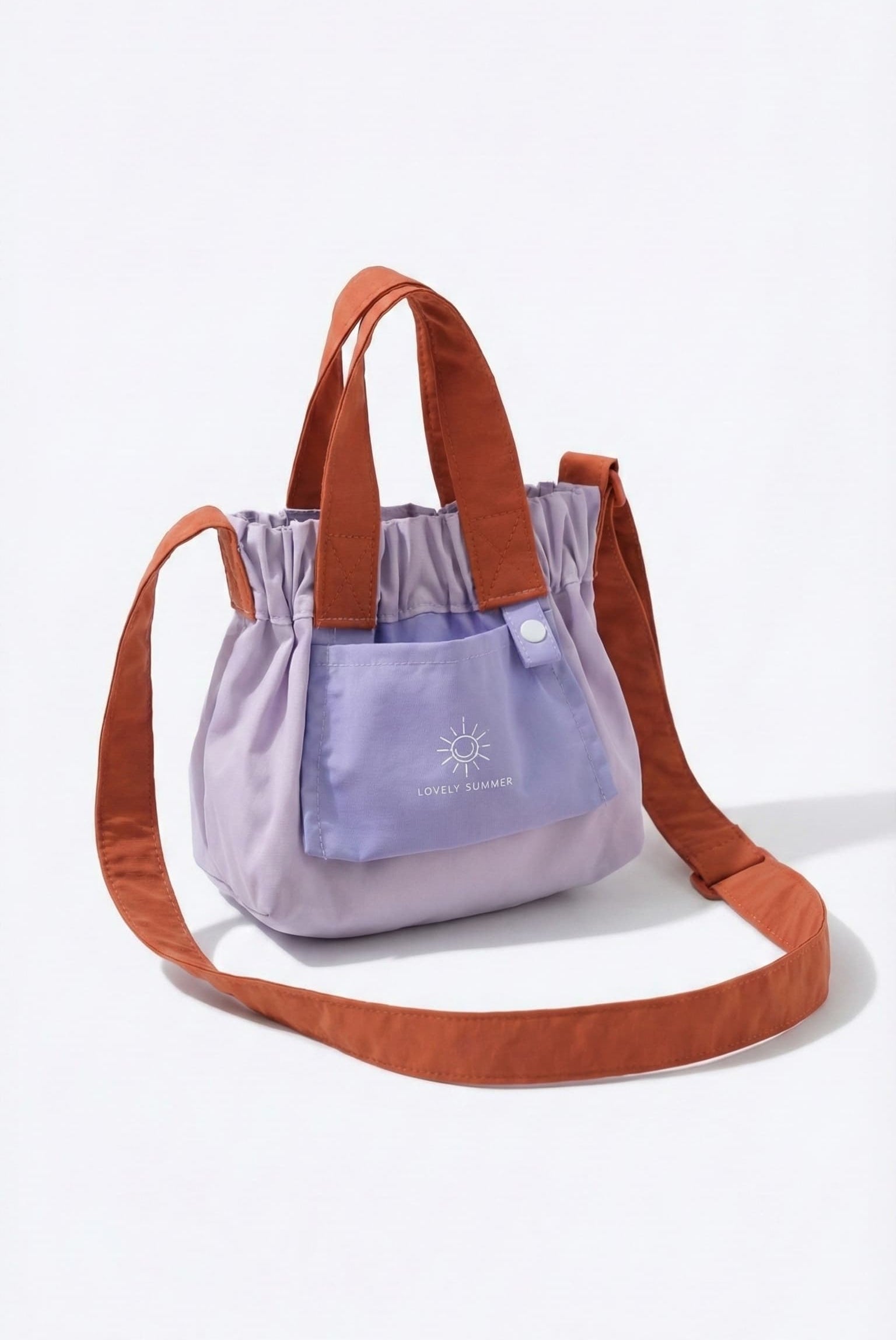Purple bag with brown handles and strap on a white background