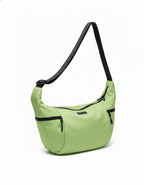 Green shoulder bag with black accents on a white background