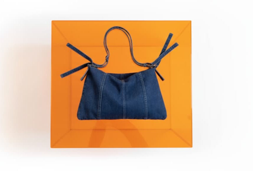 Blue denim tote bag on an orange background