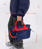 Person holding a blue and red bag with text highlighting features on a white background