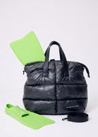 Black puffer bag with green flippers on a white background
