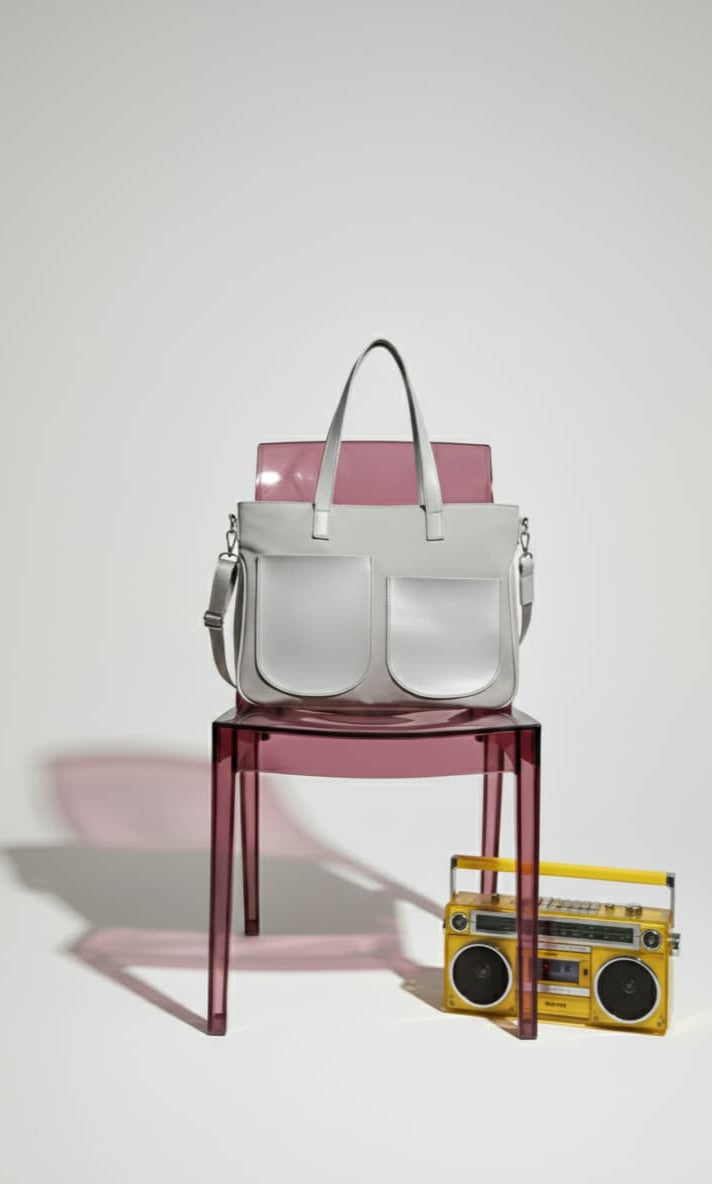 White handbag on a transparent pink chair with a yellow boombox on a white background