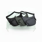 Three bags in black, gray, and dark gray on a clear stand with a white background