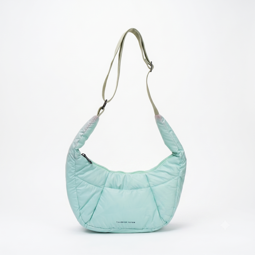 Light blue quilted handbag with a strap on a white background