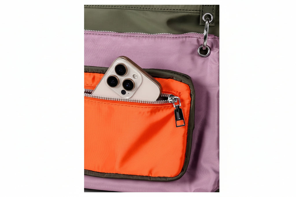 Close-up of a multicolored pouch with a phone inside, featuring orange, purple, and green sections.