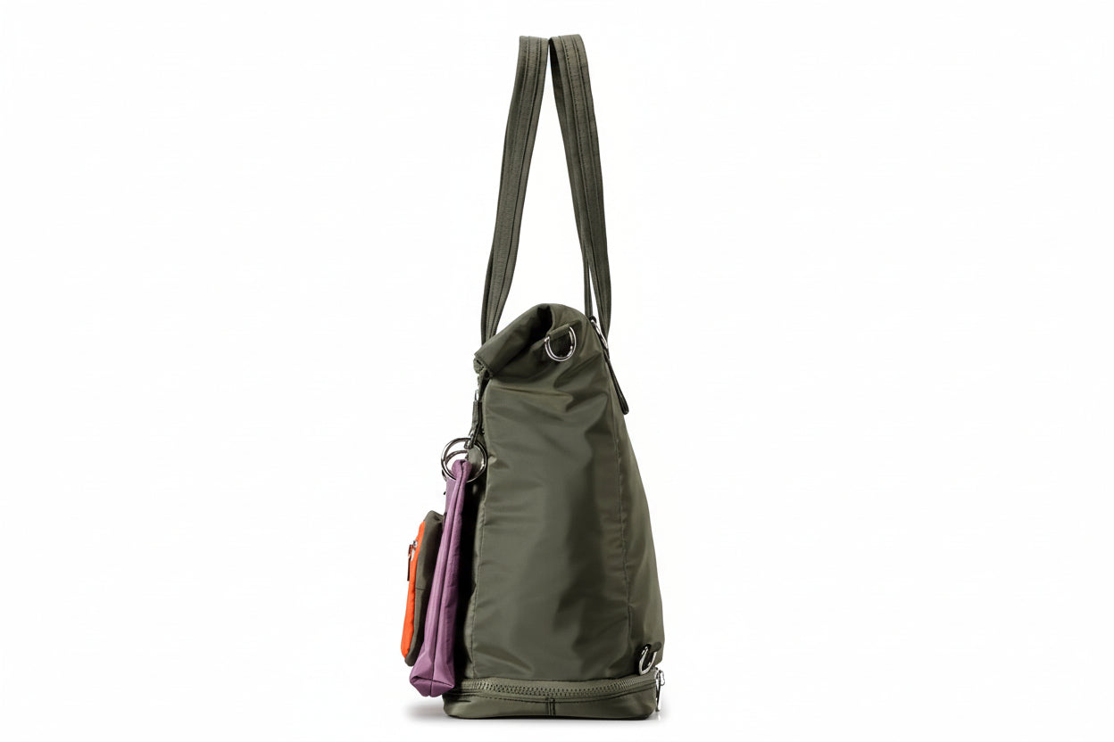 Green backpack with multiple compartments on a gray background