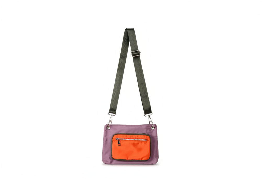 Purple crossbody bag with an orange pocket on a light gray background