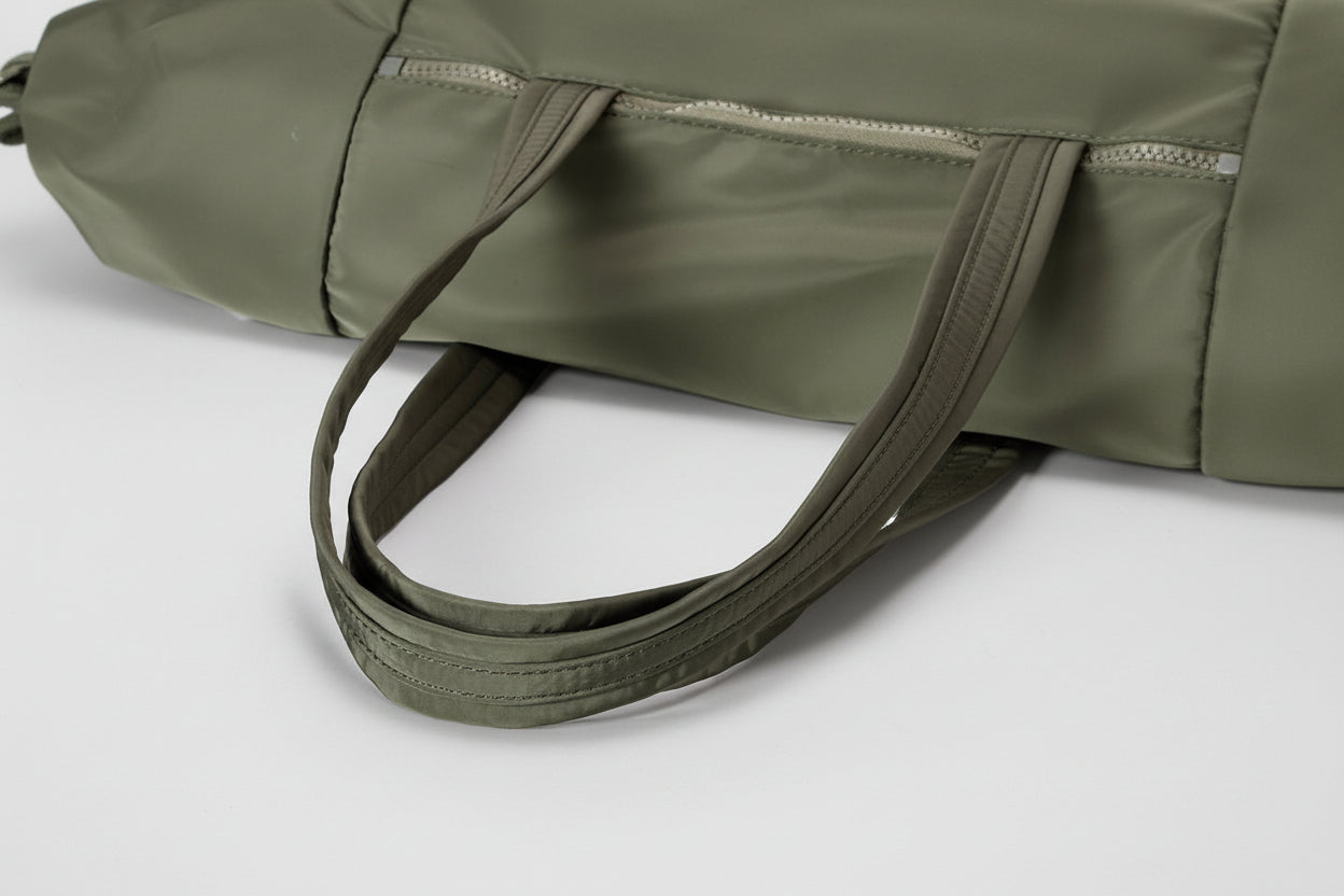 Green bag with a strap on a white background, featuring the MyOrange website.