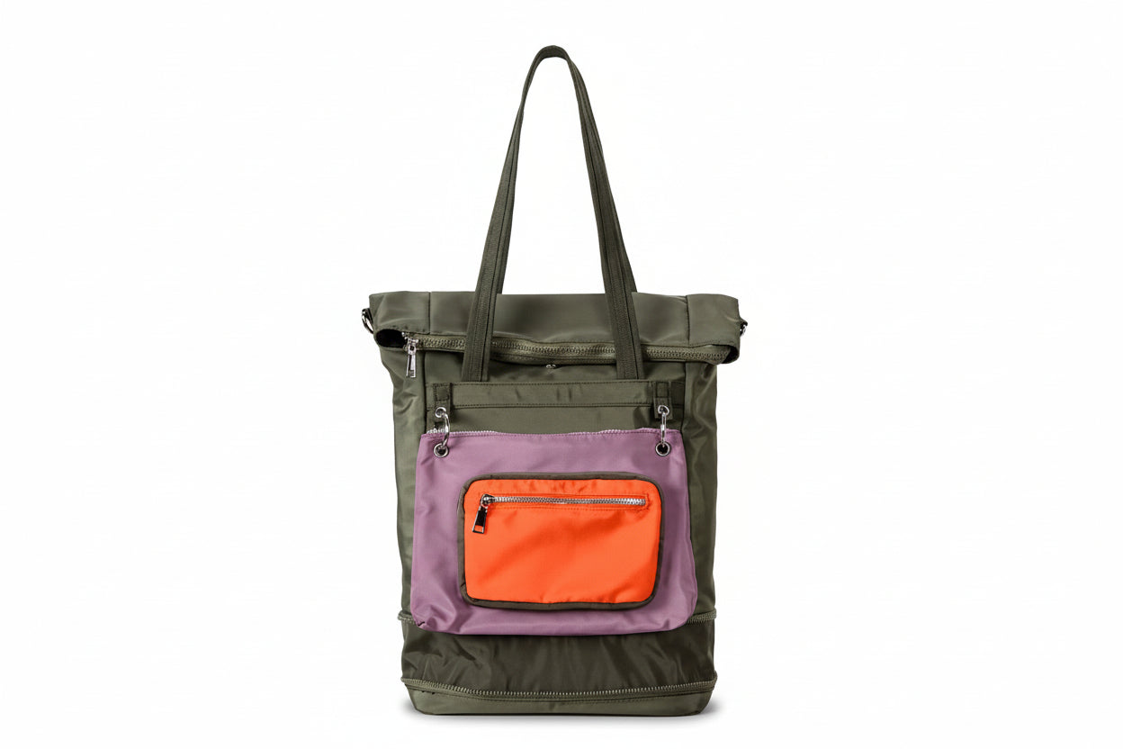 Multicolored tote bag with green, purple, and orange sections on a light gray background