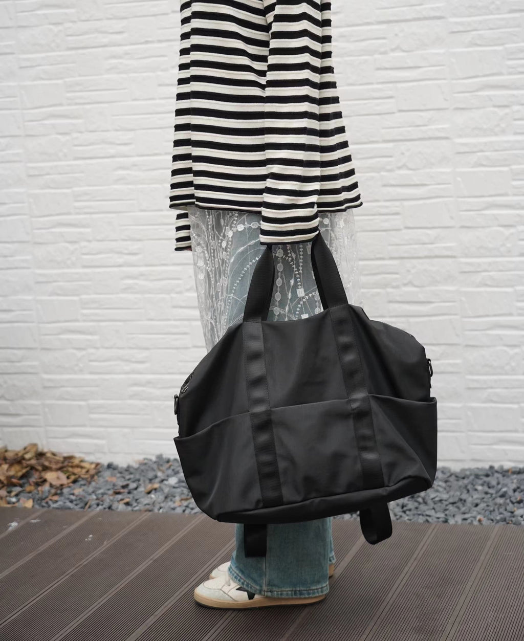 A unisex duffel tote bag with a sleek, minimal design featuring two vertical straps, dual carry handles, an adjustable shoulder strap, and side pockets. Spacious enough for travel or daily use, crafted from durable, water-resistant material with a zippered top closure. Ideal for college, gym, or casual outings.








A unisex duffel tote bag with a sleek, minimal design featuring two vertical straps, dual carry handles, an adjustable shoulder strap, and side pockets. Spacious enough for travel or daily us