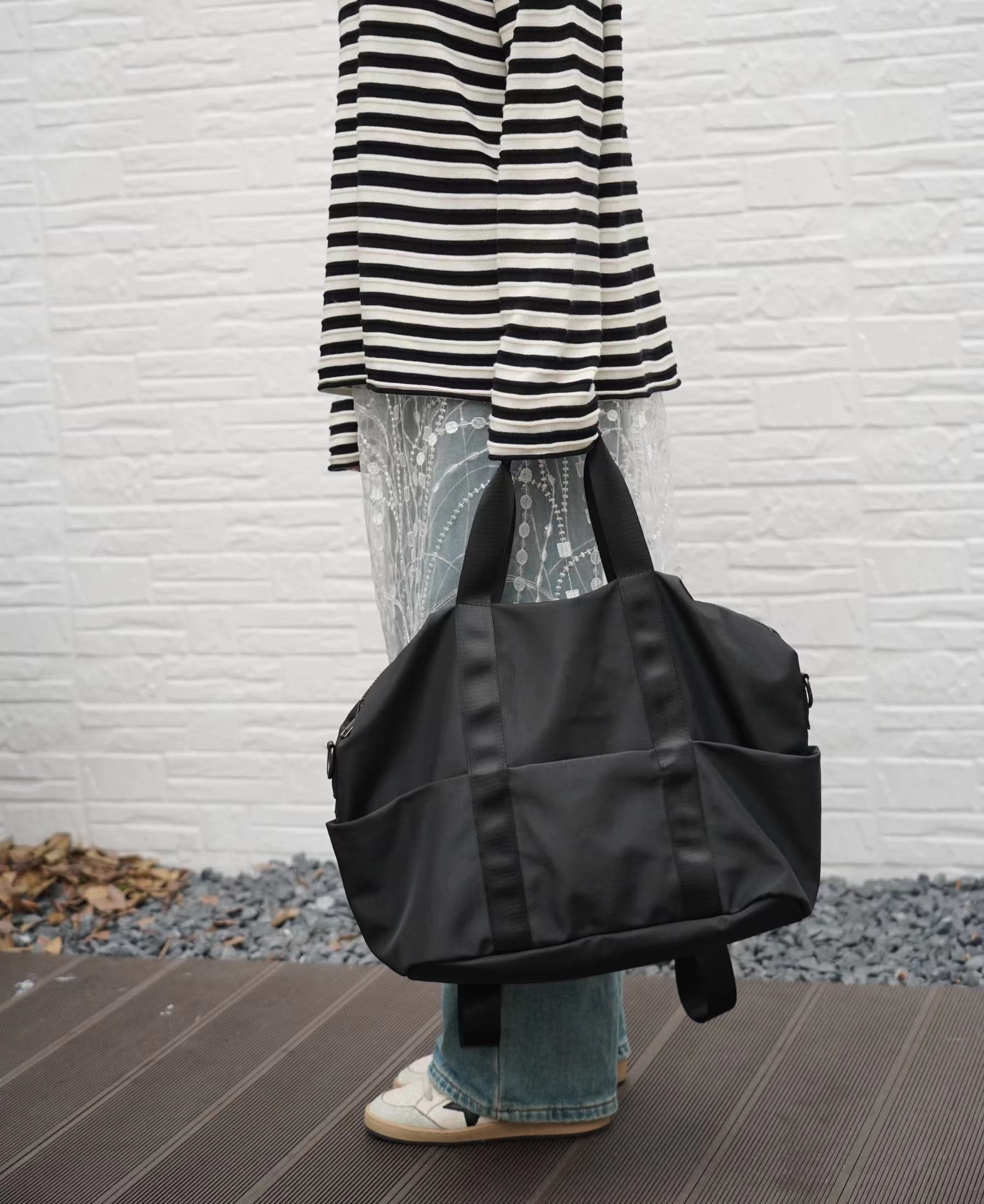 A unisex duffel tote bag with a sleek, minimal design featuring two vertical straps, dual carry handles, an adjustable shoulder strap, and side pockets. Spacious enough for travel or daily use, crafted from durable, water-resistant material with a zippered top closure. Ideal for college, gym, or casual outings.








A unisex duffel tote bag with a sleek, minimal design featuring two vertical straps, dual carry handles, an adjustable shoulder strap, and side pockets. Spacious enough for travel or daily us