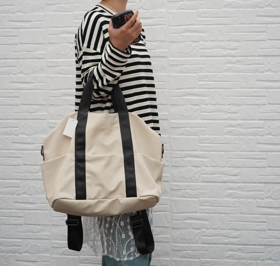 A unisex duffel tote bag with a sleek, minimal design featuring two vertical straps, dual carry handles, an adjustable shoulder strap, and side pockets. Spacious enough for travel or daily use, crafted from durable, water-resistant material with a zippered top closure. Ideal for college, gym, or casual outings.








A unisex duffel tote bag with a sleek, minimal design featuring two vertical straps, dual carry handles, an adjustable shoulder strap, and side pockets. Spacious enough for travel or daily us