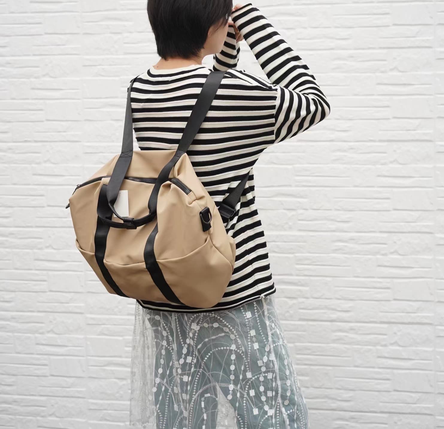 A unisex duffel tote bag with a sleek, minimal design featuring two vertical straps, dual carry handles, an adjustable shoulder strap, and side pockets. Spacious enough for travel or daily use, crafted from durable, water-resistant material with a zippered top closure. Ideal for college, gym, or casual outings.








A unisex duffel tote bag with a sleek, minimal design featuring two vertical straps, dual carry handles, an adjustable shoulder strap, and side pockets. Spacious enough for travel or daily us
