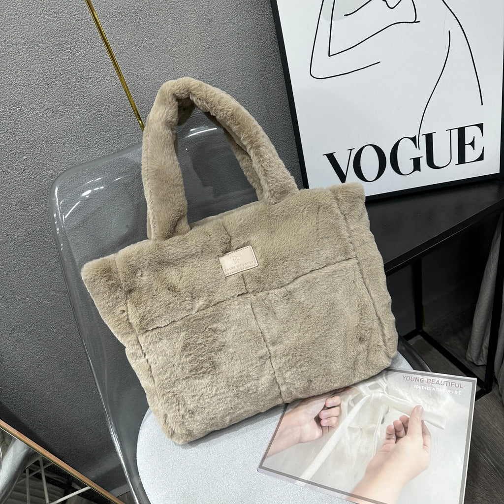 Plush faux fur tote bag with padded handles, zippered top, and spacious interior – designed for cozy winter outings and everyday comfort. Soft, lightweight, and stylish, perfect for carrying essentials in cold weather. A chic and functional piece from Tales of Totes – standing out from Indian brands like Zouk, Chumbak, and Miraggio with unique textures and winter-ready fashion flair."

