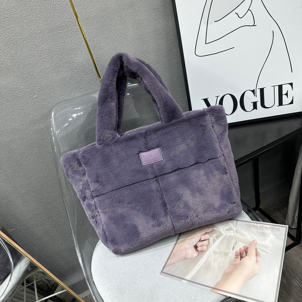 Plush faux fur tote bag with padded handles, zippered top, and spacious interior – designed for cozy winter outings and everyday comfort. Soft, lightweight, and stylish, perfect for carrying essentials in cold weather. A chic and functional piece from Tales of Totes – standing out from Indian brands like Zouk, Chumbak, and Miraggio with unique textures and winter-ready fashion flair."

