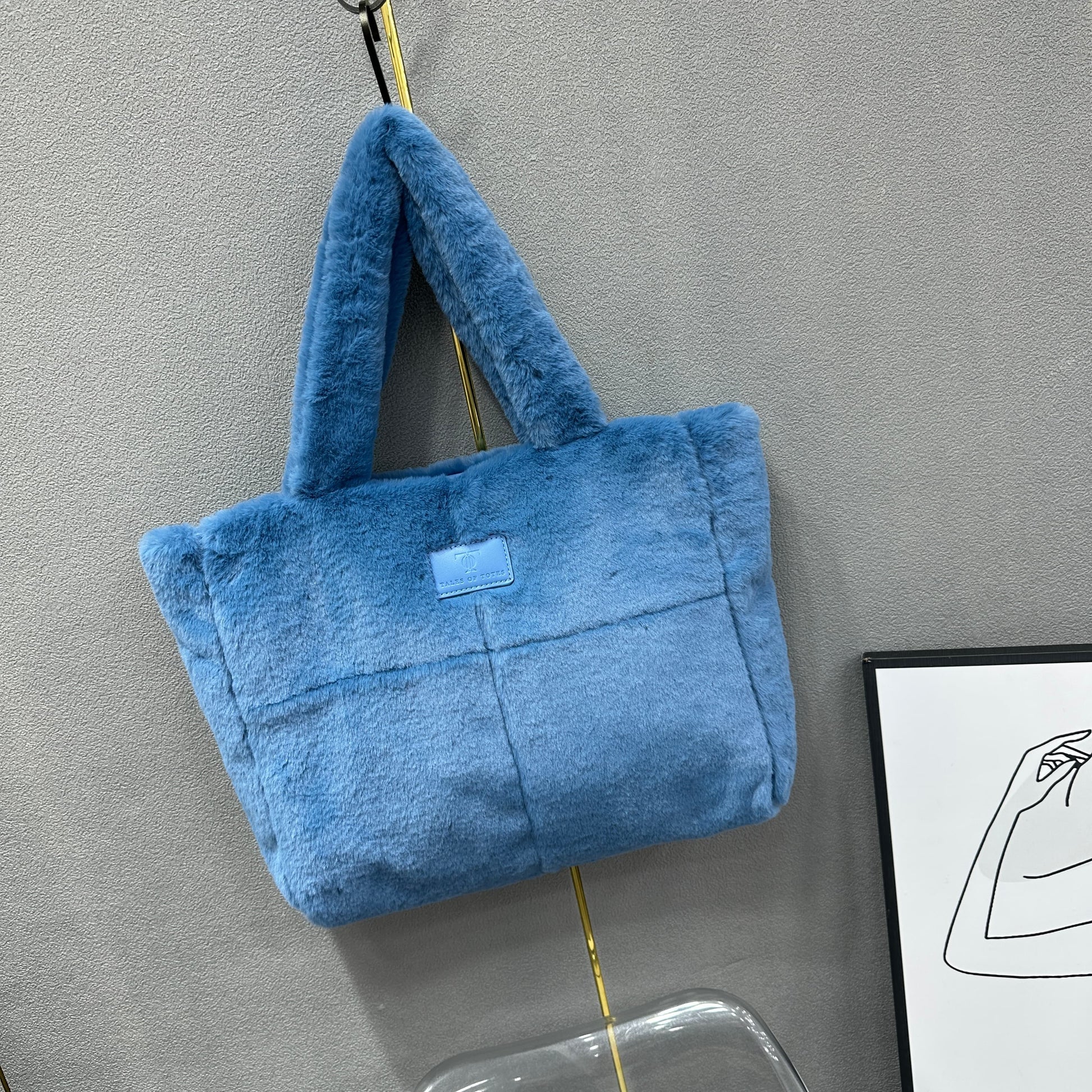 Plush faux fur tote bag with padded handles, zippered top, and spacious interior – designed for cozy winter outings and everyday comfort. Soft, lightweight, and stylish, perfect for carrying essentials in cold weather. A chic and functional piece from Tales of Totes – standing out from Indian brands like Zouk, Chumbak, and Miraggio with unique textures and winter-ready fashion flair."

