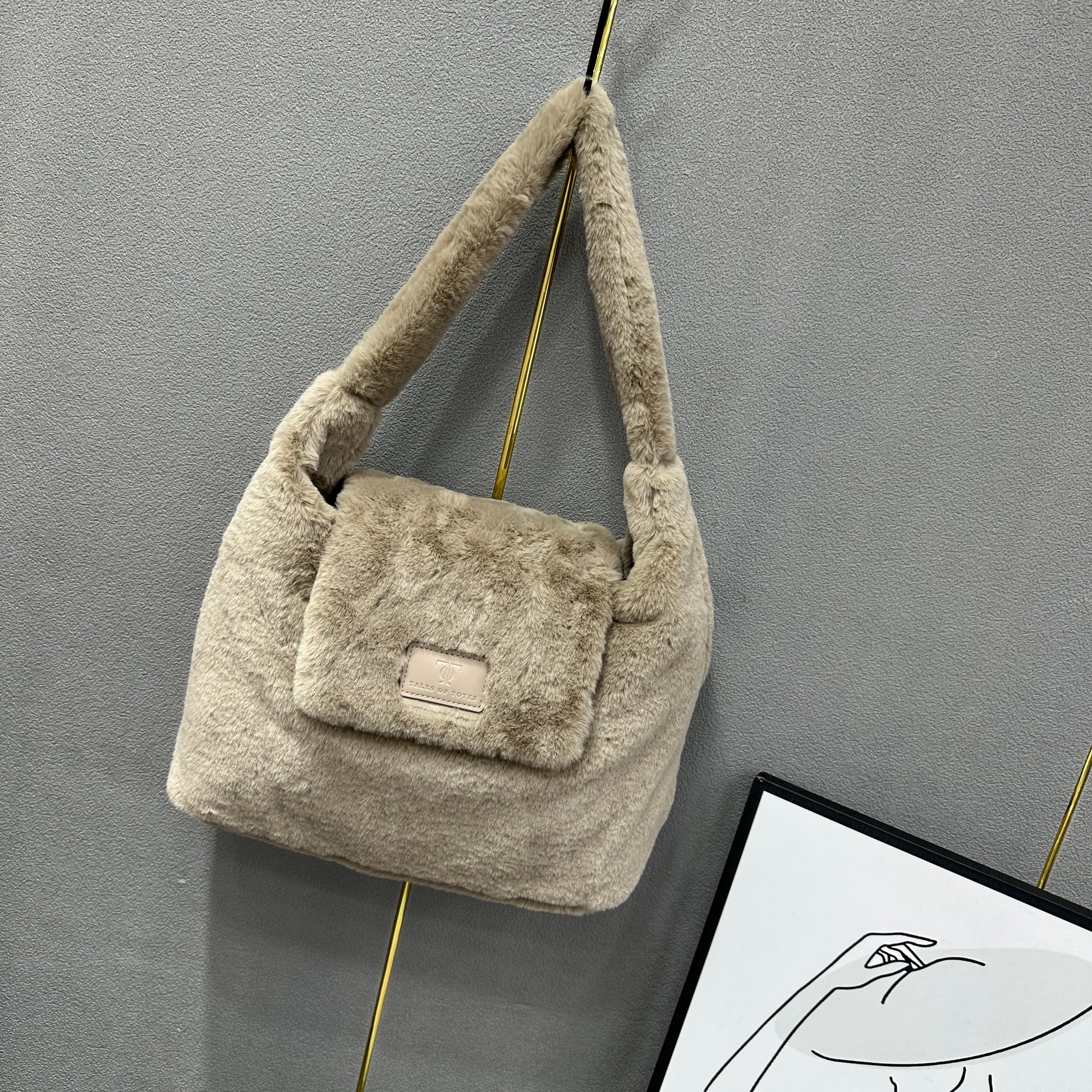 Soft faux fur tote bag with padded handles, front flap pocket, and zippered main compartment – designed for cozy winter style and functional everyday use. Spacious enough for essentials like cosmetics, wallet, and phone. A trendy winter accessory from Tales of Totes, offering stylish comfort beyond Indian brands like Zouk, Chumbak, and Miraggio."

