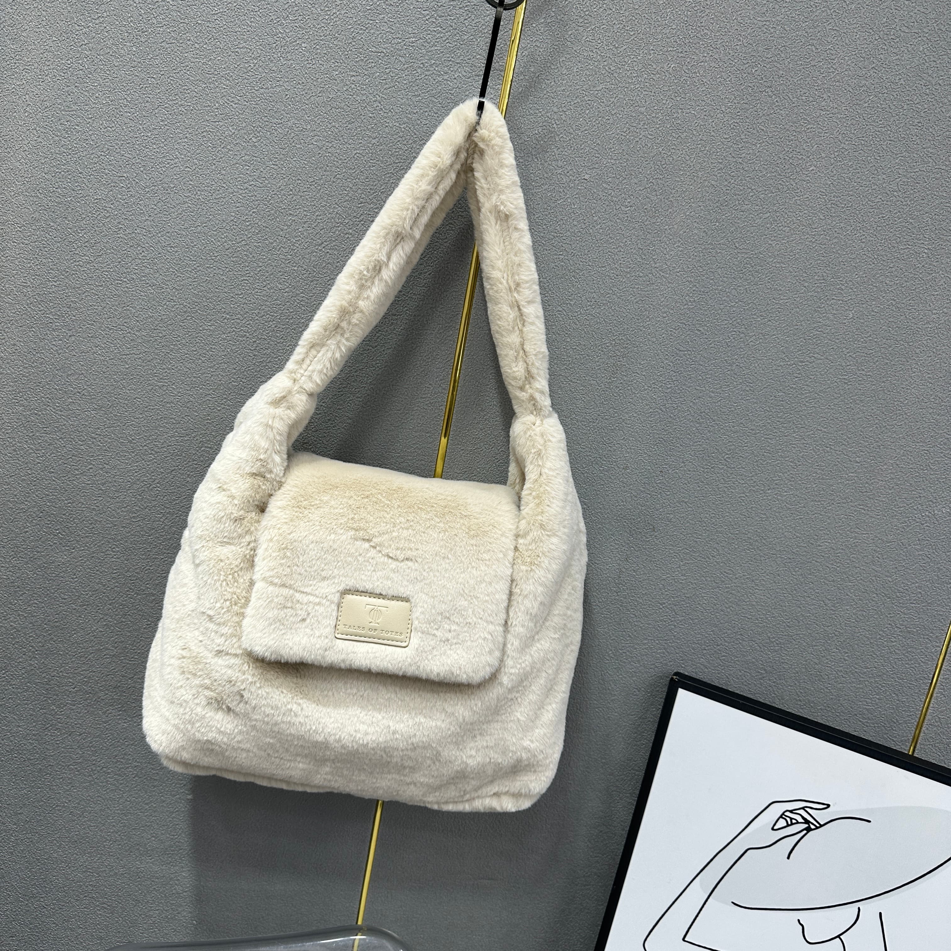 Soft faux fur tote bag with padded handles, front flap pocket, and zippered main compartment – designed for cozy winter style and functional everyday use. Spacious enough for essentials like cosmetics, wallet, and phone. A trendy winter accessory from Tales of Totes, offering stylish comfort beyond Indian brands like Zouk, Chumbak, and Miraggio."

