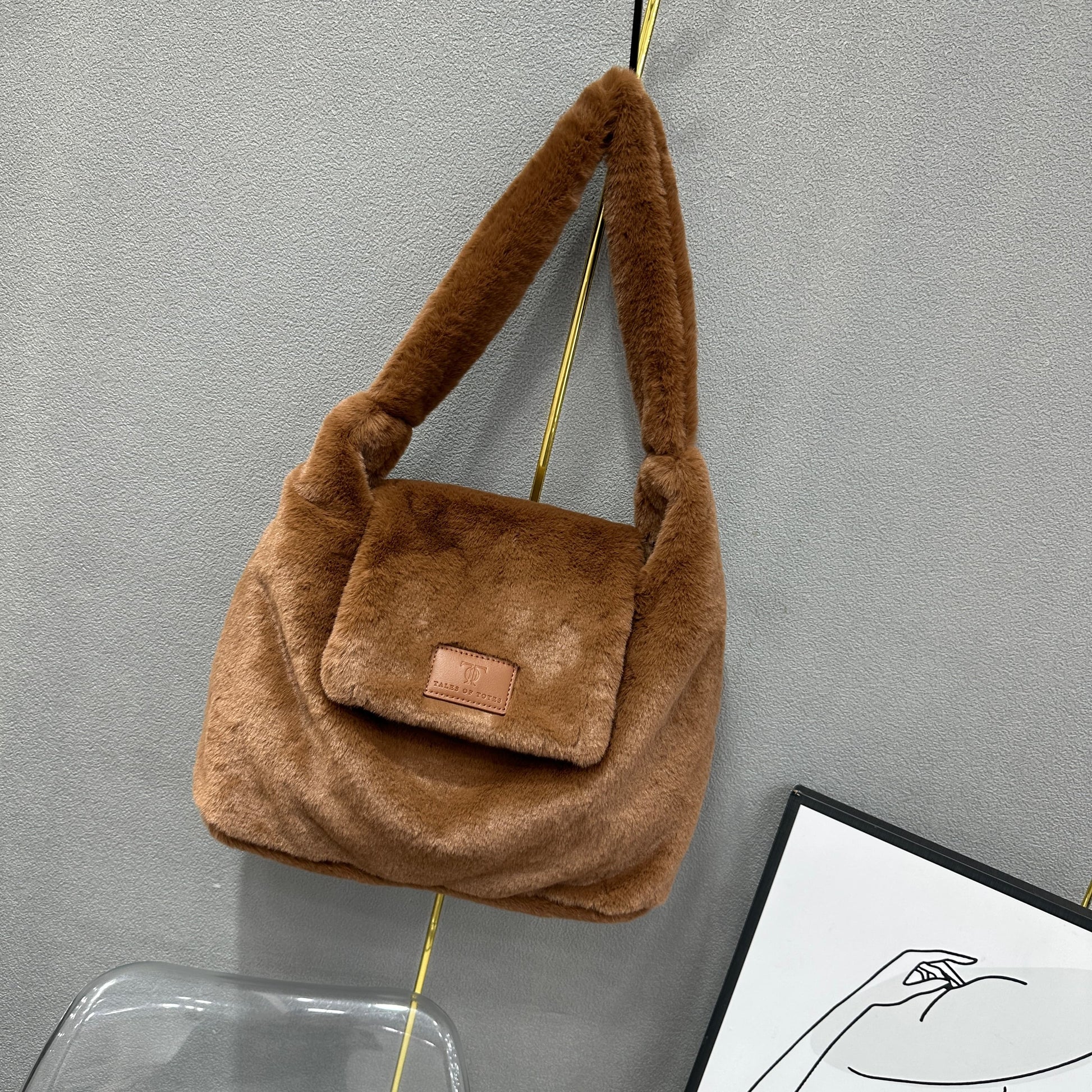 Soft faux fur tote bag with padded handles, front flap pocket, and zippered main compartment – designed for cozy winter style and functional everyday use. Spacious enough for essentials like cosmetics, wallet, and phone. A trendy winter accessory from Tales of Totes, offering stylish comfort beyond Indian brands like Zouk, Chumbak, and Miraggio."

