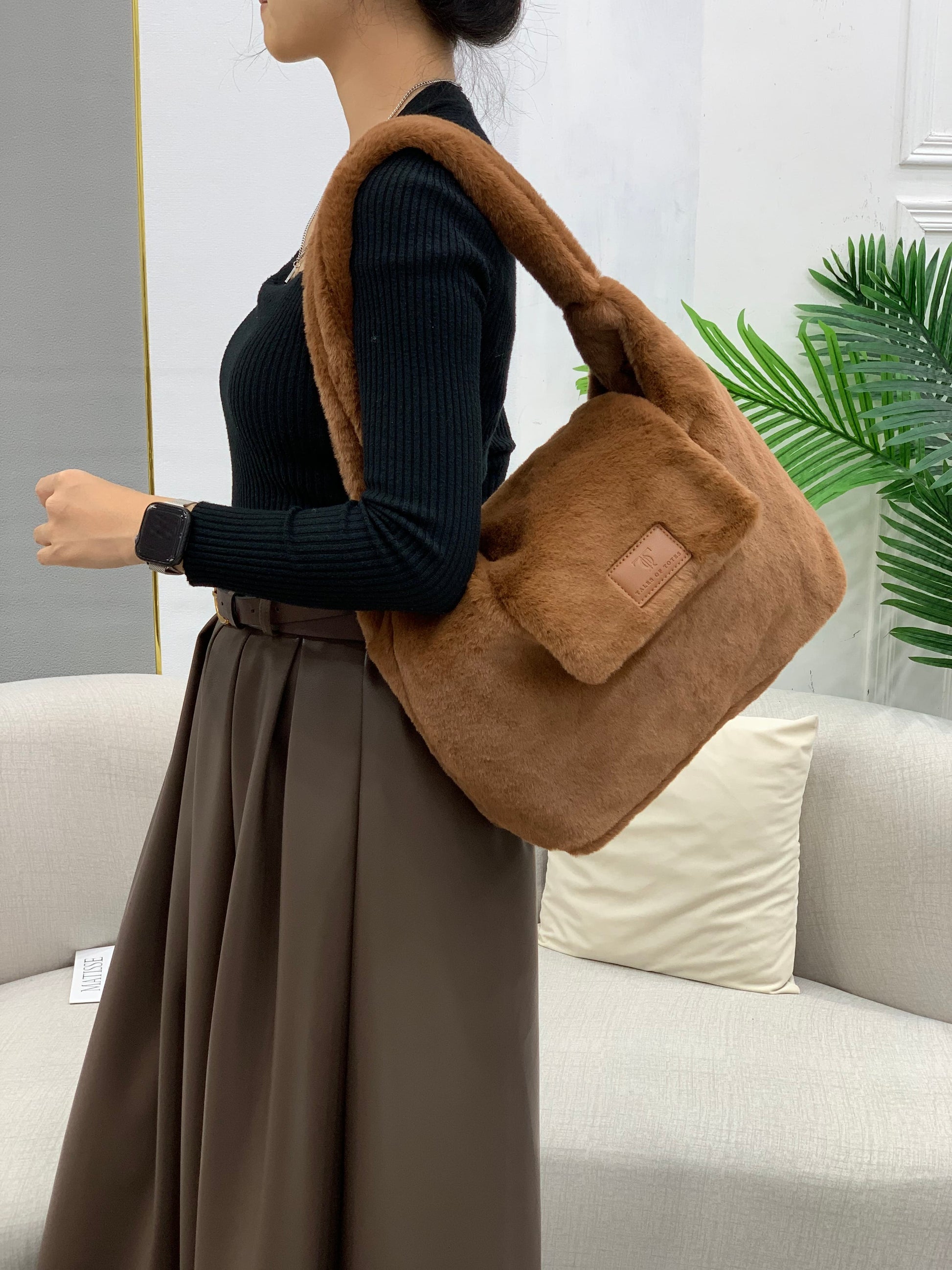 Soft faux fur tote bag with padded handles, front flap pocket, and zippered main compartment – designed for cozy winter style and functional everyday use. Spacious enough for essentials like cosmetics, wallet, and phone. A trendy winter accessory from Tales of Totes, offering stylish comfort beyond Indian brands like Zouk, Chumbak, and Miraggio."

