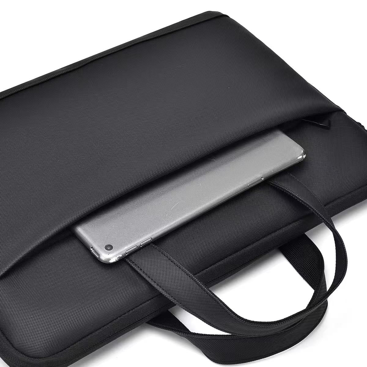 Black laptop bag with a silver laptop inside on a white background Black laptop office tote bag for men and women by Tales of Tote, premium faux leather formal bag designed for Indian professionals — sleek, minimalist, lightweight, padded laptop compartment, ideal for work, meetings, hybrid jobs, gifting, and daily commute. Stylish work tote with zipper closure, dual handles, and waterproof finish. Unisex corporate tote for executives, startup founders, students, and remote workers. Best office bag India 20