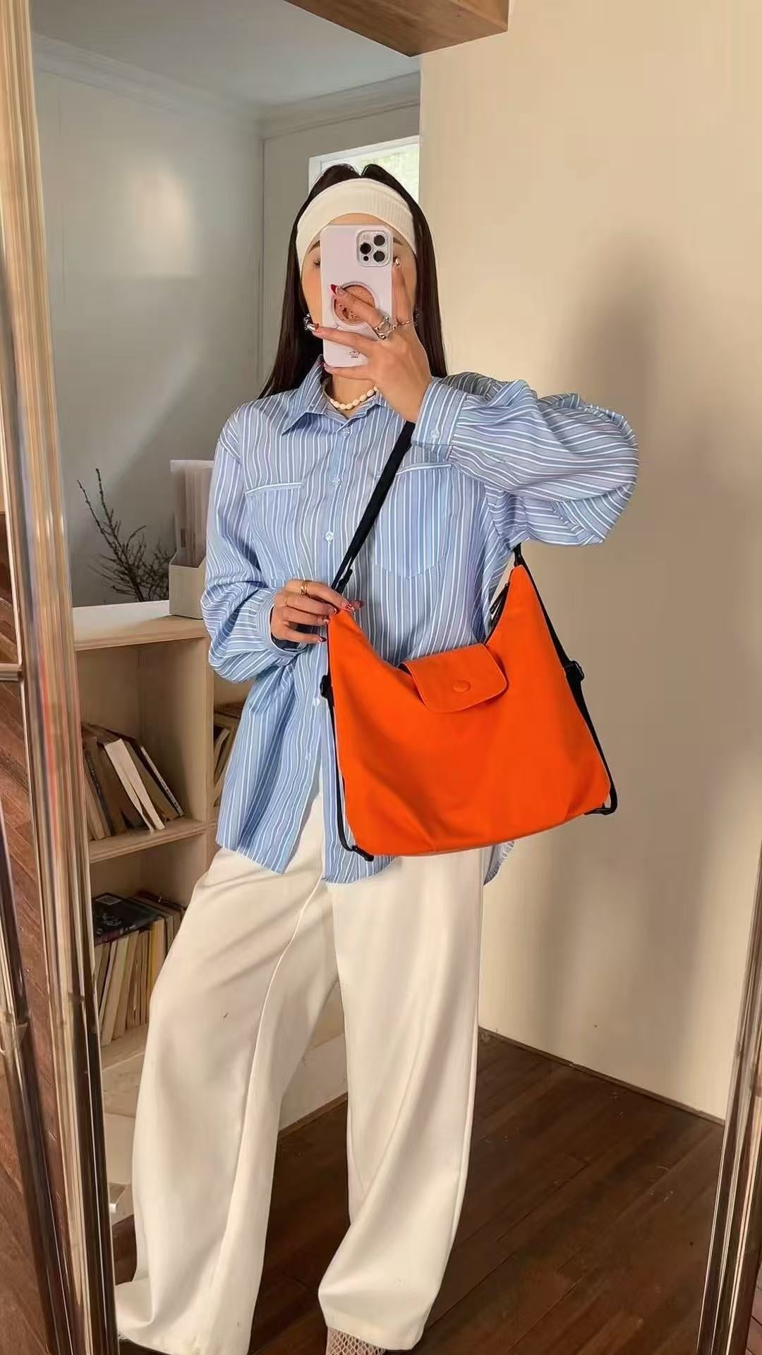 Person holding an orange bag in a room with a bookshelf.Black and orange bags on a white surface with a neutral background,laptop tote bag for women, tote bag for office use, college tote bag with zipper, and stylish bags for girls. You can also target users with specific needs by using long-tail phrases like vegan leather tote bag or tote bag for daily use in India. To understand the market better, keep an eye on competitors such as Lavie, Baggit, and Caprese, all of which are major players in the Indian 