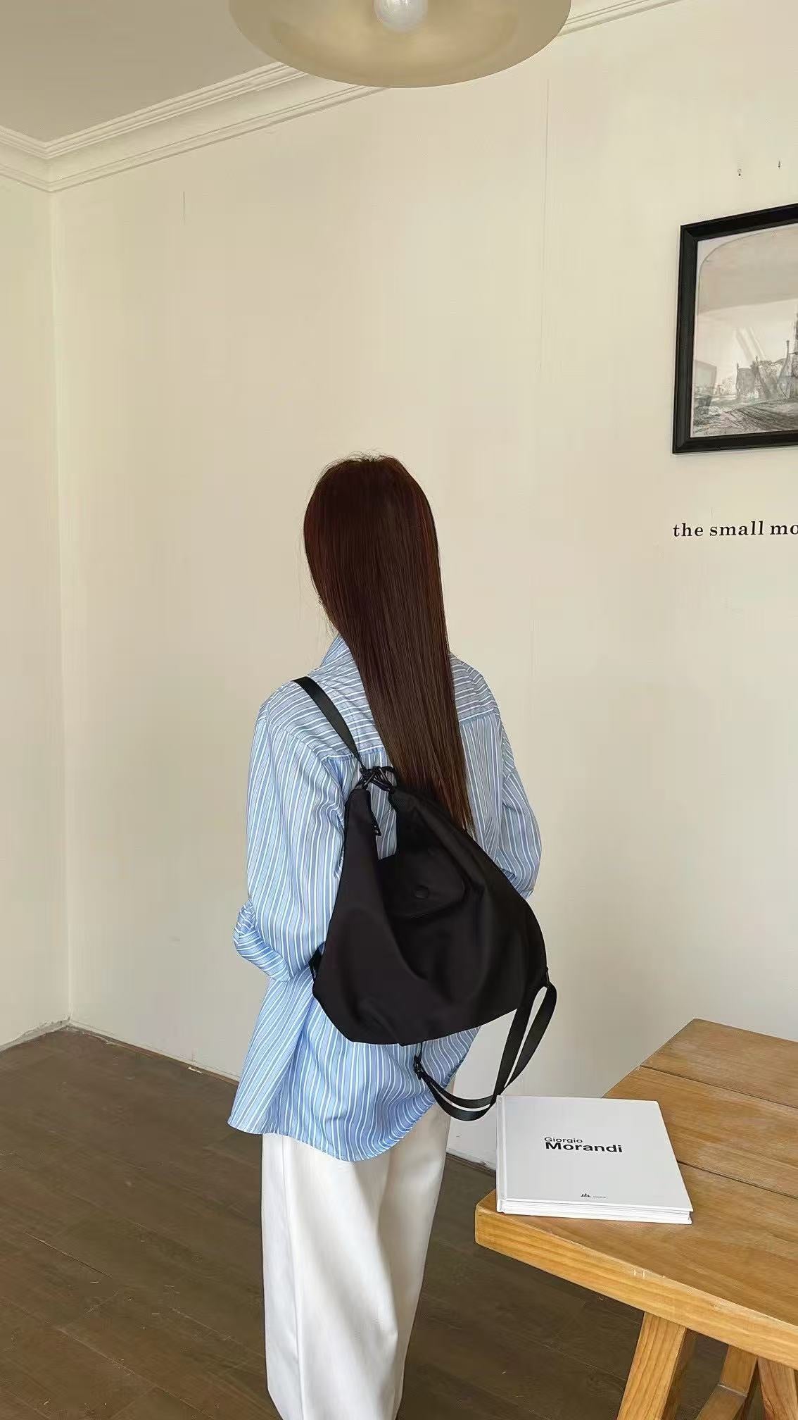 Person with a black backpack standing in a room with a table and book.Black and orange bags on a white surface with a neutral background,laptop tote bag for women, tote bag for office use, college tote bag with zipper, and stylish bags for girls. You can also target users with specific needs by using long-tail phrases like vegan leather tote bag or tote bag for daily use in India. To understand the market better, keep an eye on competitors such as Lavie, Baggit, and Caprese, all of which are major players i