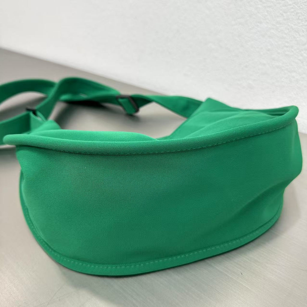 Trendy emerald green crescent half-moon shoulder bag for women, durable canvas, versatile for daily use, ethnic wear, and casual outings in India. This stylish sling bag offers a modern minimalist design, spacious interior, functioning as a chic carryall or small hobo tote.