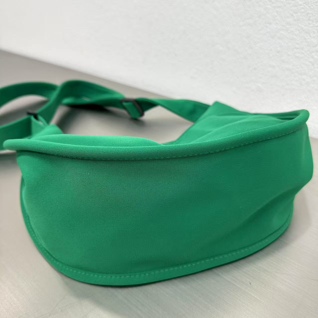 Trendy emerald green crescent half-moon shoulder bag for women, durable canvas, versatile for daily use, ethnic wear, and casual outings in India. This stylish sling bag offers a modern minimalist design, spacious interior, functioning as a chic carryall or small hobo tote.