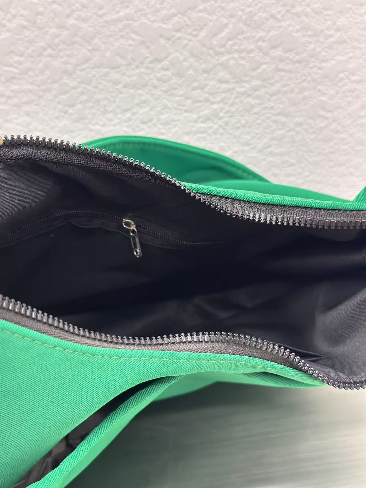 Trendy emerald green crescent half-moon shoulder bag for women, durable canvas, versatile for daily use, ethnic wear, and casual outings in India. This stylish sling bag offers a modern minimalist design, spacious interior, functioning as a chic carryall or small hobo tote.