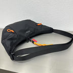 Black bag with a strap on a light gray surfaceWaterproof tote bag with a durable exterior and a bright orange interior. Features an adjustable strap and multiple pockets for organization. Ideal for travel, gym, or daily use in India.