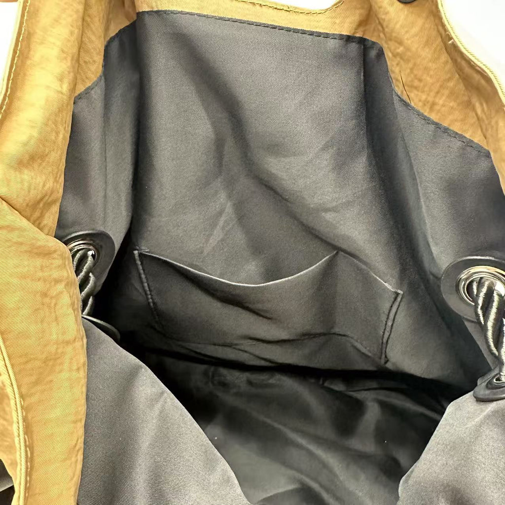 Close-up of a brown leather jacket with black lining,High-quality red tote bag for women and girls from a new Indian fashion brand. Features a unique top-fold flap design and sturdy braided black rope handles. Perfect for carrying laptops and essentials, making it a stylish and functional bag for office, college, or casual outings in India. A chic and trending design for the modern Indian woman, available online with free shipping.