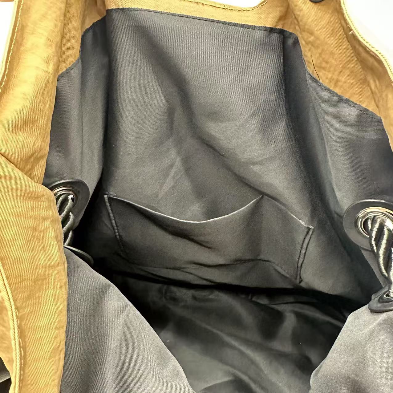 Close-up of a brown leather jacket with black lining,High-quality red tote bag for women and girls from a new Indian fashion brand. Features a unique top-fold flap design and sturdy braided black rope handles. Perfect for carrying laptops and essentials, making it a stylish and functional bag for office, college, or casual outings in India. A chic and trending design for the modern Indian woman, available online with free shipping.