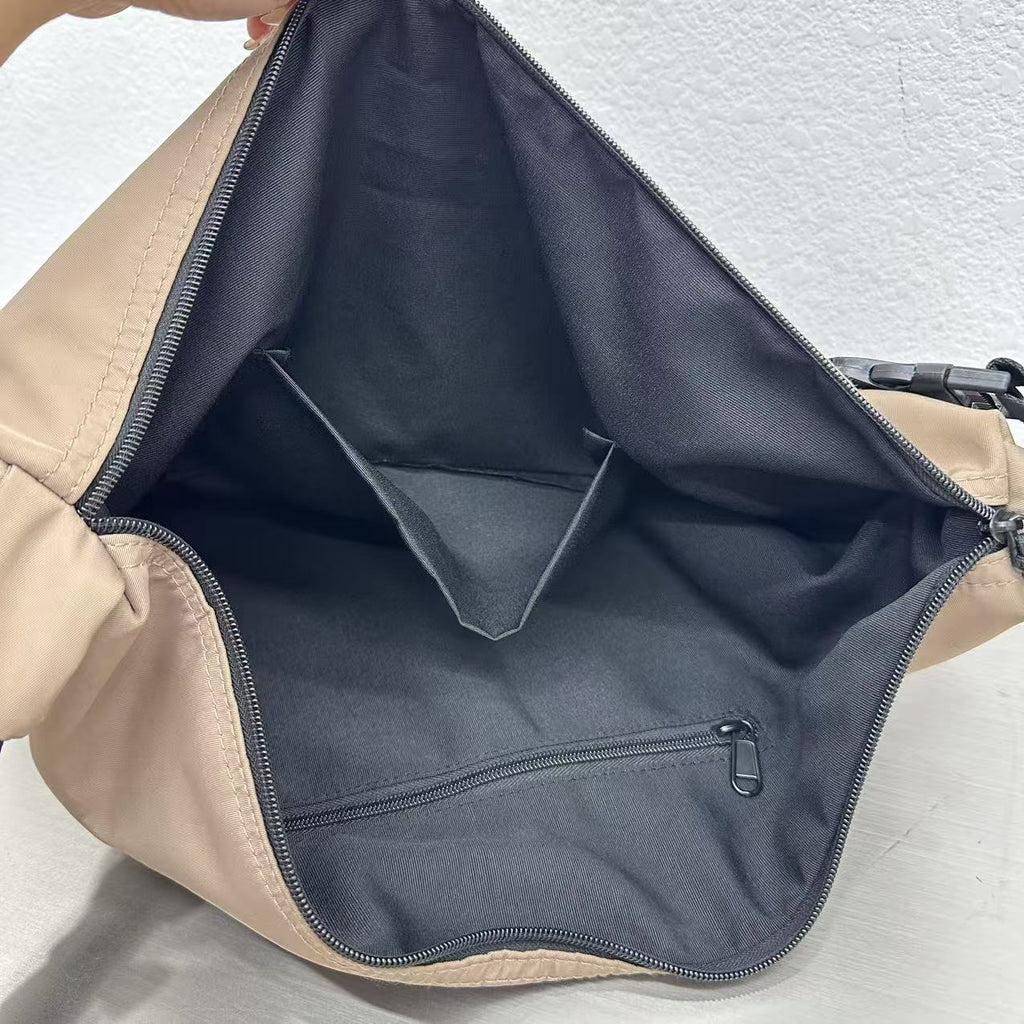 Close-up of a beige bag with a black interior pocket on a light gray background,Convertible nylon tote bag with detachable crossbody strap, zippered front pocket, and main compartment. Available in olive green, black, and beige.