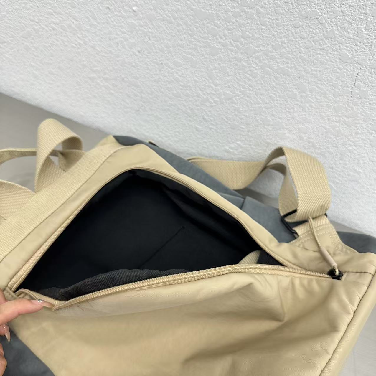 Beige backpack with open front compartment on a light gray backgStylish travel backpack, durable everyday bag, versatile shoulder tote, convertible backpack purse, waterproof utility bag, modern casual rucksack, ergonomic daypack, trendy laptop bag, multi-functional women's backpack, secure anti-theft design, spacious college bag, fashion-forward accessory, urban commuter pack, comfortable carry-all, premium quality satchel, practical work bag, chic student backpack, easy-access travel essential, organround