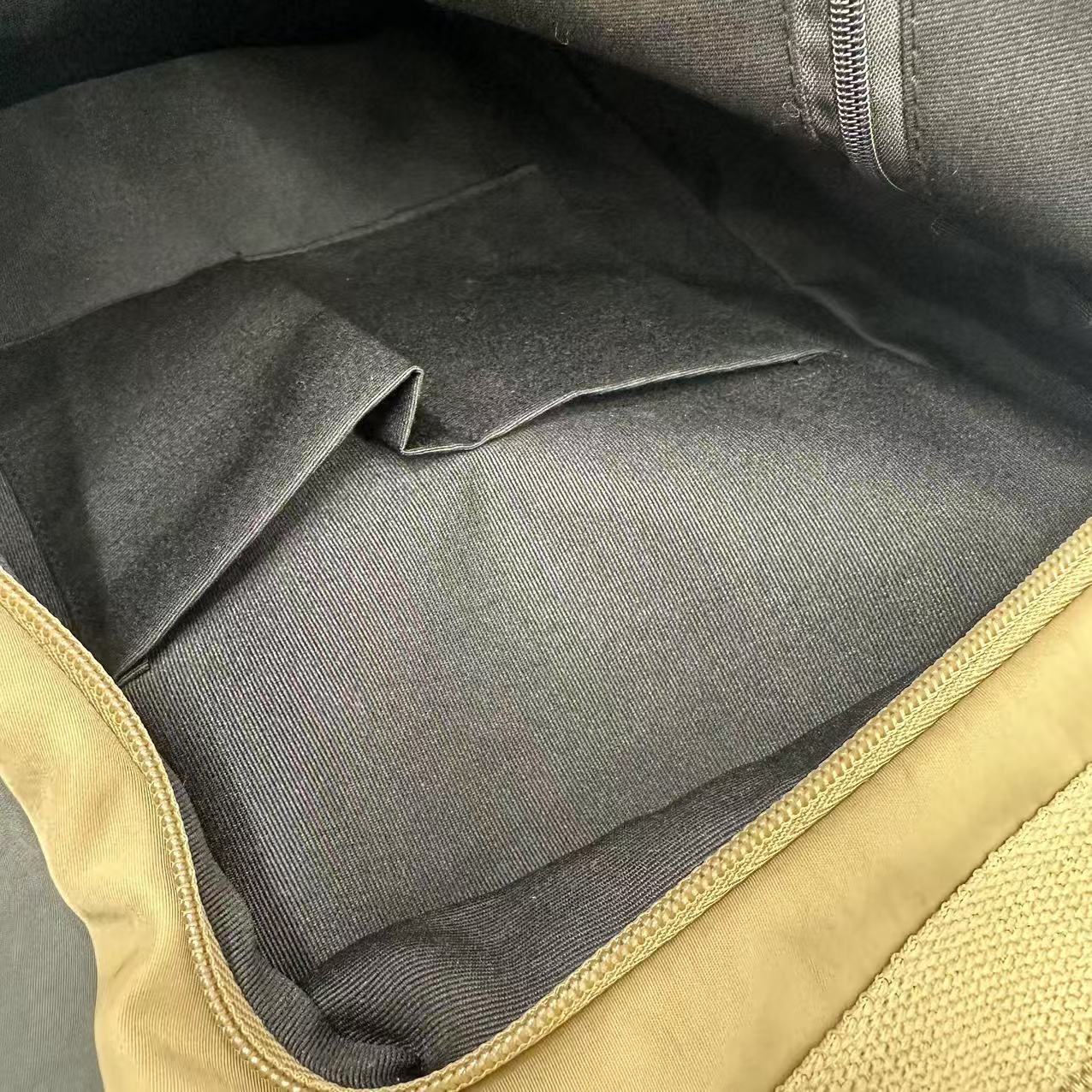 Close-up of a gray fabric interior of a bag with beige trimStylish travel backpack, durable everyday bag, versatile shoulder tote, convertible backpack purse, waterproof utility bag, modern casual rucksack, ergonomic daypack, trendy laptop bag, multi-functional women's backpack, secure anti-theft design, spacious college bag, fashion-forward accessory, urban commuter pack, comfortable carry-all, premium quality satchel, practical work bag, chic student backpack, easy-access travel essential, organized perso