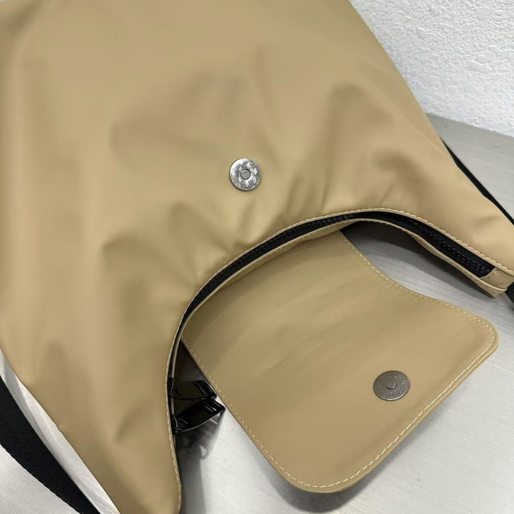 Close-up of a beige bag with metal buttons on a white surface,laptop tote bag for women, tote bag for office use, college tote bag with zipper, and stylish bags for girls. You can also target users with specific needs by using long-tail phrases like vegan leather tote bag or tote bag for daily use in India. To understand the market better, keep an eye on competitors such as Lavie, Baggit, and Caprese, all of which are major players in the Indian handbag space, along with brands like Zouk and Hidesign that c
