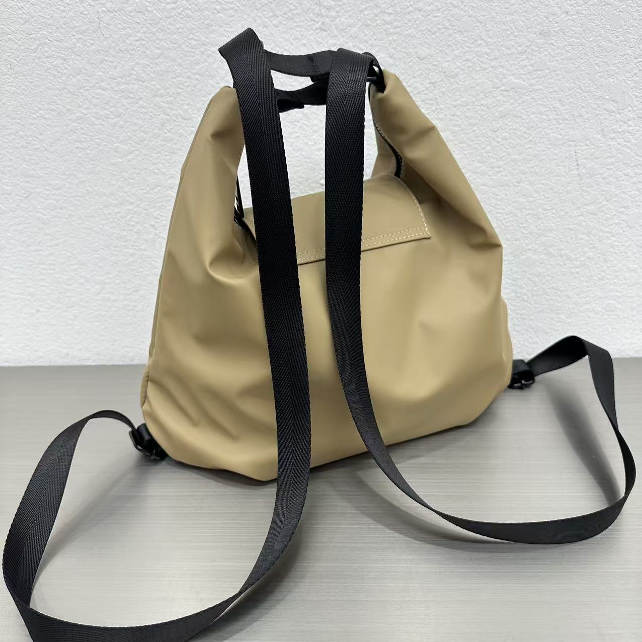 Beige bag with black straps on a light gray surface,laptop tote bag for women, tote bag for office use, college tote bag with zipper, and stylish bags for girls. You can also target users with specific needs by using long-tail phrases like vegan leather tote bag or tote bag for daily use in India. To understand the market better, keep an eye on competitors such as Lavie, Baggit, and Caprese, all of which are major players in the Indian handbag space, along with brands like Zouk and Hidesign that cater to sp