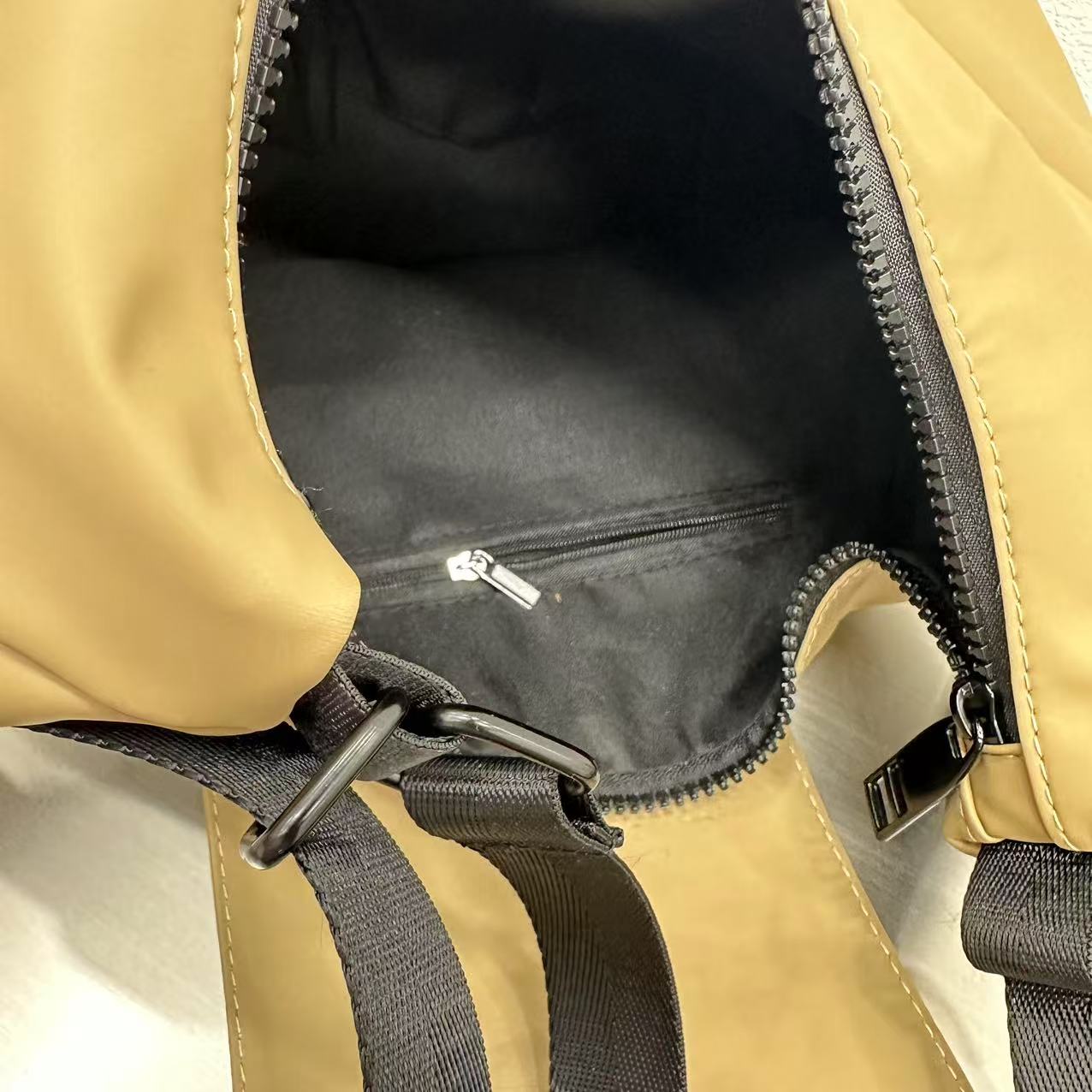 Close-up of a beige backpack with a black interior and zipper,laptop tote bag for women, tote bag for office use, college tote bag with zipper, and stylish bags for girls. You can also target users with specific needs by using long-tail phrases like vegan leather tote bag or tote bag for daily use in India. To understand the market better, keep an eye on competitors such as Lavie, Baggit, and Caprese, all of which are major players in the Indian handbag space, along with brands like Zouk and Hidesign that c