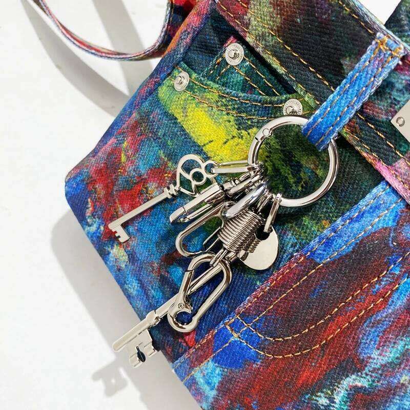 Keychain with keys attached to a colorful textured surface