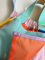 Trendy multi-color casual college tote bag with mesh detailing and adjustable straps.