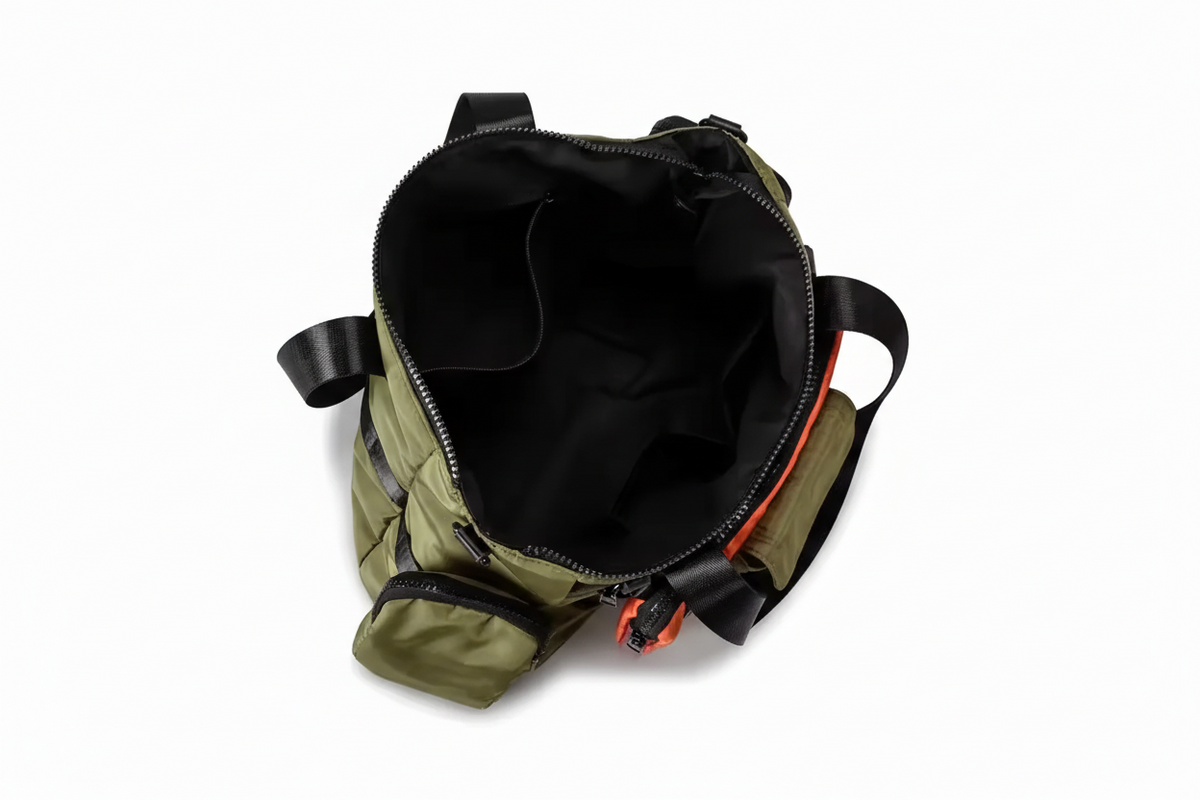 Green backpack with black interior on a light gray background, featuring the brand 'Red manjun'.