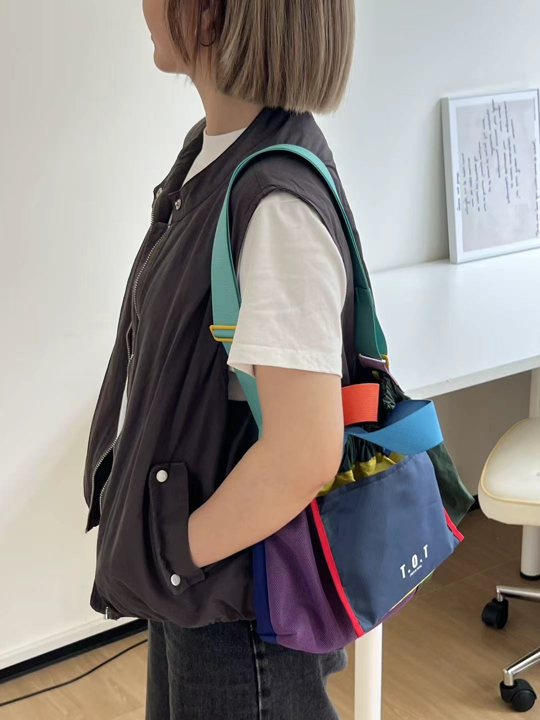 Trendy multi-color casual college tote bag with mesh detailing and adjustable straps.