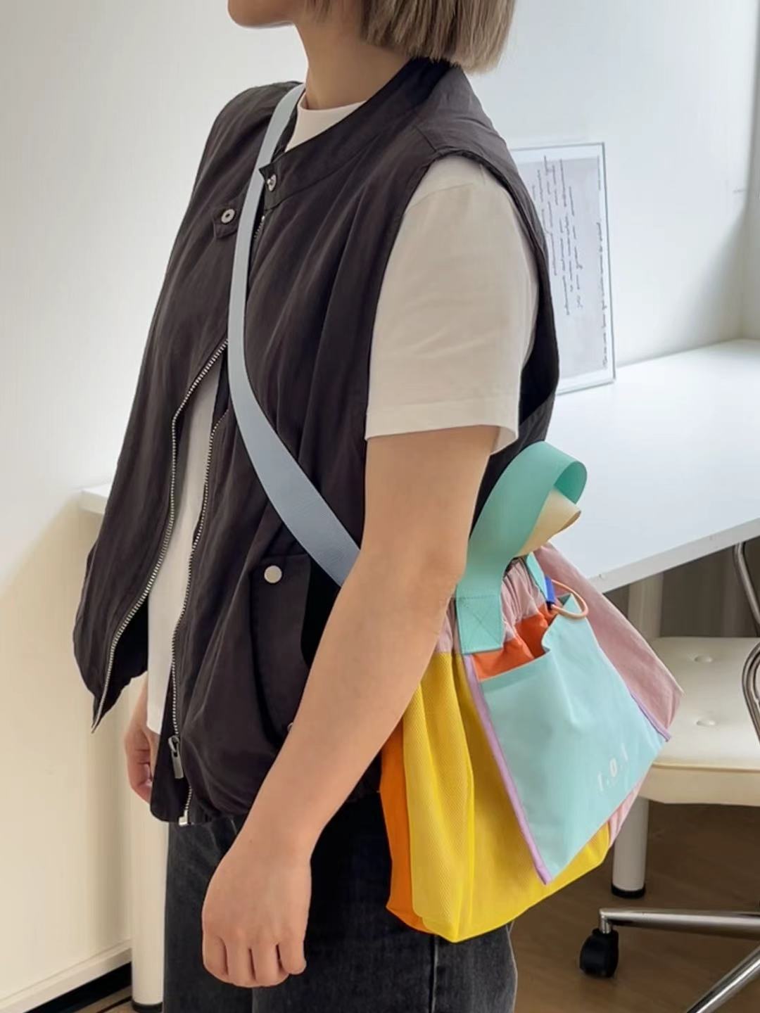 Trendy multi-color casual college tote bag with mesh detailing and adjustable straps.