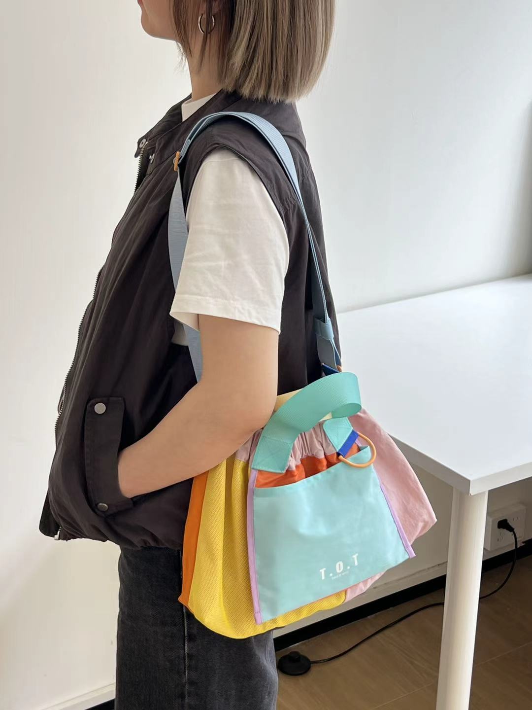 Trendy multi-color casual college tote bag with mesh detailing and adjustable straps.